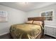 Cozy bedroom with wood-paneled bed frame and dark hardwood floors at 2725 Shoreland Sw Dr, Atlanta, GA 30331