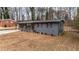 Single-story home with gray painted brick and mature trees on a spacious lot at 2725 Shoreland Sw Dr, Atlanta, GA 30331