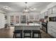 Bright kitchen features a granite island, stainless appliances, and gray cabinets at 2725 Shoreland Sw Dr, Atlanta, GA 30331