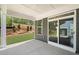 Covered back porch featuring a concrete floor, gray siding, and view of the backyard at 44 Easton Park Blvd, Dallas, GA 30157