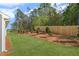 Backyard features well-manicured lawn, landscaped borders, and a wood fence at 44 Easton Park Blvd, Dallas, GA 30157