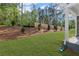 Backyard featuring green lawn, wood fence, trees and landscaping at 44 Easton Park Blvd, Dallas, GA 30157