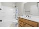 Bathroom with shower-tub combo, wood vanity, and marble-look floor at 44 Easton Park Blvd, Dallas, GA 30157