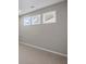 Neutral bedroom with three windows offering natural light and plush carpeting at 44 Easton Park Blvd, Dallas, GA 30157