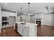 Modern kitchen with island, stainless steel appliances, and open to the living room with fireplace at 44 Easton Park Blvd, Dallas, GA 30157