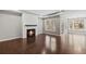 Spacious living room with wood floors, a fireplace with a wooden mantel and multiple large windows at 44 Easton Park Blvd, Dallas, GA 30157