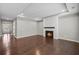 Open-concept living room with wood floors and a fireplace surrounded by lots of natural light at 44 Easton Park Blvd, Dallas, GA 30157