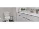 Modern bathroom with white cabinets and brushed gold fixtures at 687 Banton Nw Dr, Atlanta, GA 30318