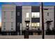 Contemporary townhome with gray and white exterior, front deck, and steps at 687 Banton Nw Dr, Atlanta, GA 30318