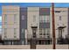 Modern three-story townhome with gray and white siding, deck, and fenced yard at 687 Banton Nw Dr, Atlanta, GA 30318