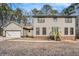 Two-story house with beige siding, green door, and wooden steps at 1791 Lake George Dr, Lithia Springs, GA 30122