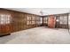 Spacious living room featuring wood walls, a brick fireplace, and large windows at 1791 Lake George Dr, Lithia Springs, GA 30122