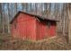 Red wooden shed in wooded area at 1791 Lake George Dr, Lithia Springs, GA 30122