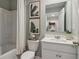 Clean bathroom with white vanity, shower/tub combo, and a mirror at 2098 Moss Hill Rd, Stone Mountain, GA 30088