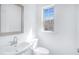 Clean half bathroom with white fixtures, and a modern sink and toilet at 3812 Thatcher Sw Dr, Marietta, GA 30008