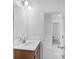 Bright bathroom featuring a large mirror, wood vanity, and a doorway leading to additional rooms at 3812 Thatcher Sw Dr, Marietta, GA 30008