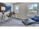 This home office features sleek furniture, a lounge chair, and an abundance of natural light at 3812 Thatcher Sw Dr, Marietta, GA 30008