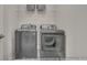 The well-lit laundry room includes modern washer and dryer at 3812 Thatcher Sw Dr, Marietta, GA 30008