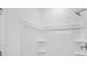 Close up of a bright white shower with shelves at 3812 Thatcher Sw Dr, Marietta, GA 30008