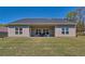 View of a cozy back porch with outdoor seating and a spacious grassy backyard at 5424 Flat Rock Point, Stonecrest, GA 30038