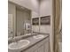 Bright bathroom featuring double sinks, white cabinets, and modern fixtures at 5424 Flat Rock Point, Stonecrest, GA 30038