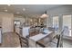 Dining area connecting the kitchen and living room, featuring modern table and abundant light at 5424 Flat Rock Point, Stonecrest, GA 30038