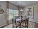 Dining room showcasing a wooden table, pendant lighting, and large windows with decorative curtains at 5424 Flat Rock Point, Stonecrest, GA 30038