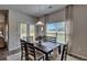 Dining room with a dark wood table, upholstered chairs, and natural light from a sliding glass door at 5424 Flat Rock Point, Stonecrest, GA 30038