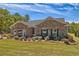 Charming brick home showcasing a well-manicured lawn and vibrant landscaping under a blue sky at 5424 Flat Rock Point, Stonecrest, GA 30038