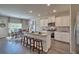 Stylish kitchen featuring white cabinets, a granite island with seating, and stainless steel appliances at 5424 Flat Rock Point, Stonecrest, GA 30038