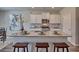 Close up of kitchen island, granite countertop, seating, view of stainless steel microwave and gas stove at 5424 Flat Rock Point, Stonecrest, GA 30038