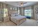 Cozy main bedroom featuring neutral decor, two large windows, stylish furnishings, and soft carpet flooring at 5424 Flat Rock Point, Stonecrest, GA 30038