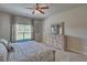 Bright main bedroom with ceiling fan, soft carpet, and large windows offering lots of natural light at 5424 Flat Rock Point, Stonecrest, GA 30038