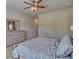 Bedroom with ceiling fan, soft carpet, full dresser, and large windows offering lots of natural light at 5424 Flat Rock Point, Stonecrest, GA 30038