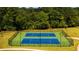 Overhead view of well-maintained community tennis courts surrounded by green landscaping and fencing at 5424 Flat Rock Point, Stonecrest, GA 30038