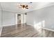 Bedroom featuring gray walls, wood floors, ceiling fan and an adjoining bathroom at 113 Rue Fontaine # 113, Lithonia, GA 30038