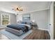 Comfortable bedroom with a large window, neutral colors, hardwood floors, and a ceiling fan at 113 Rue Fontaine # 113, Lithonia, GA 30038