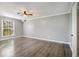 Spacious bedroom with hardwood floors and ceiling fan at 113 Rue Fontaine # 113, Lithonia, GA 30038
