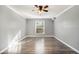 Bright bedroom with hardwood floors and ceiling fan at 113 Rue Fontaine # 113, Lithonia, GA 30038