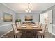 Traditional dining room with hardwood floors, neutral colors, a large table, and seating for eight at 113 Rue Fontaine # 113, Lithonia, GA 30038