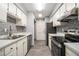 Updated kitchen with stainless steel appliances and tile backsplash at 113 Rue Fontaine # 113, Lithonia, GA 30038