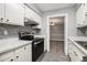 Updated kitchen with stainless steel appliances and view of dining area at 113 Rue Fontaine # 113, Lithonia, GA 30038