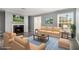 Bright living room featuring hardwood floors, large windows, a fireplace, and comfortable seating at 113 Rue Fontaine # 113, Lithonia, GA 30038