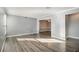 Open concept living room and dining area with hardwood floor at 113 Rue Fontaine # 113, Lithonia, GA 30038
