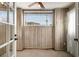 Bright sunroom features wood-paneled walls, a ceiling fan, and window with blinds at 113 Rue Fontaine # 113, Lithonia, GA 30038