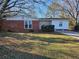 Brick and white ranch house with well-maintained lawn at 1613 Gilston Ct, Decatur, GA 30032