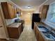 Kitchen features wood cabinets, gas stove, and view to dining area at 1613 Gilston Ct, Decatur, GA 30032