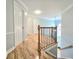 Upstairs hallway with hardwood floors and access to bedrooms at 215 Deer Cliff, Lawrenceville, GA 30043