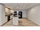 Basement kitchen with white cabinets, black appliances, and island at 208 Hickory Rdg, Cumming, GA 30040