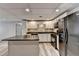 Stylish basement kitchen with white cabinets and an island at 208 Hickory Rdg, Cumming, GA 30040